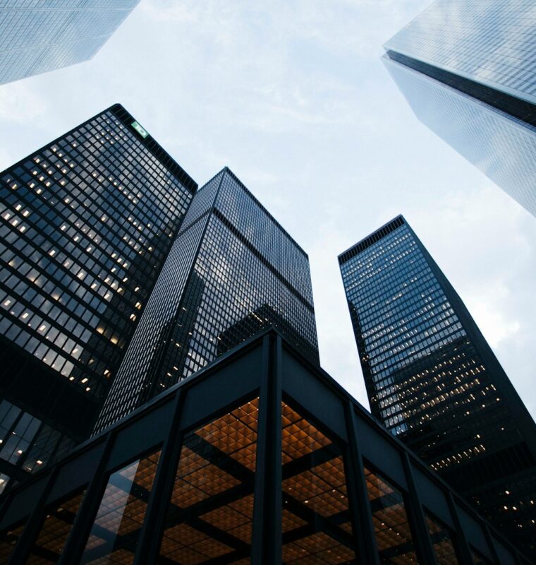 Photo by Sean Pollock low angle photo of city high rise buildings during daytime